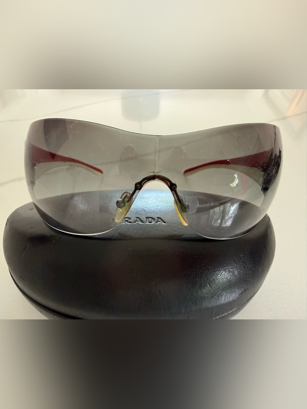 Prada Rimless Shield Sunglasses in Clear Gradient with Red/White stripe - Picture 6 of 11